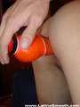 An orange dildo is going to and through - Picture 13